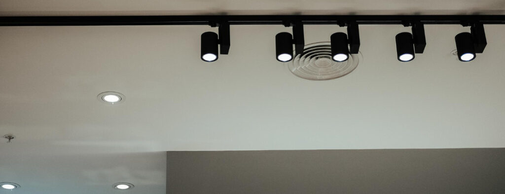 A modern ceiling with track and recessed lighting, emphasizing the importance of DIY recessed lights safety for proper installation.