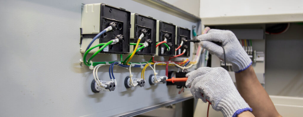 Electrician performs an Electrical Panel Upgrade by connecting wires inside a residential control box.